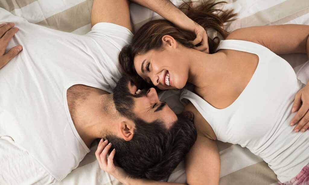 emotionally connected couple smiling after tantric sex